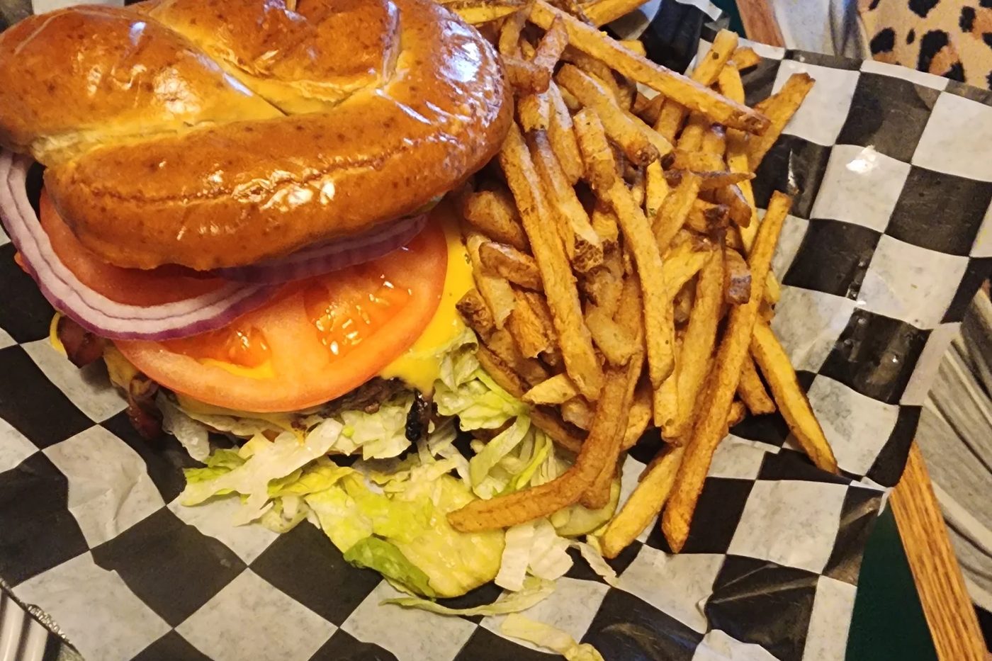 Angus burger on a pretzel bun with fresh-cut fries